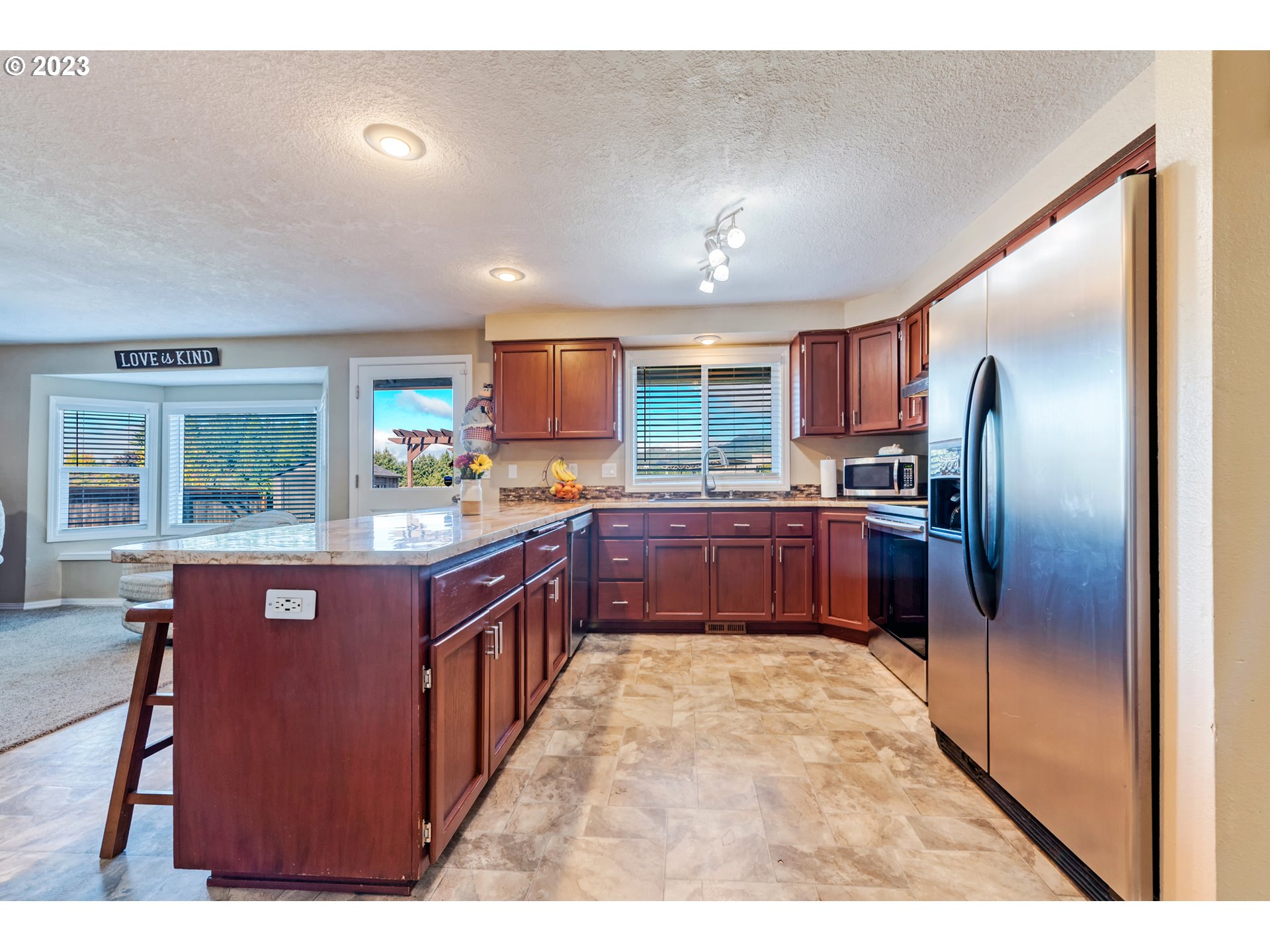 7370 B Street Springfield, OR 97478 - Photo 11 of 41 a kitchen with stainless steel appliances granite countertop a stove a sink dishwasher a refrigerator and a microwave