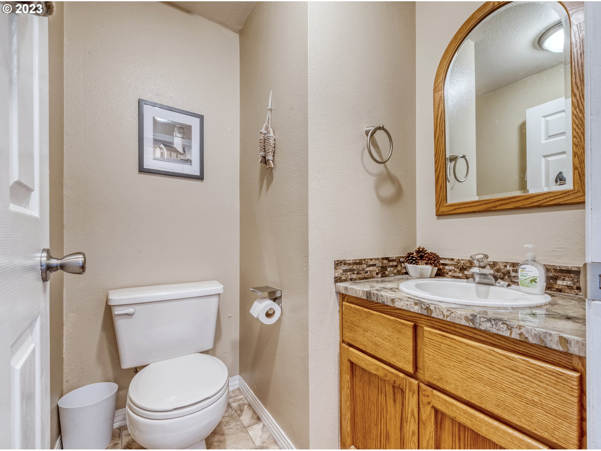 7370 B Street Springfield, OR 97478 - Photo 17 of 41 a bathroom with a granite countertop toilet sink and mirror
