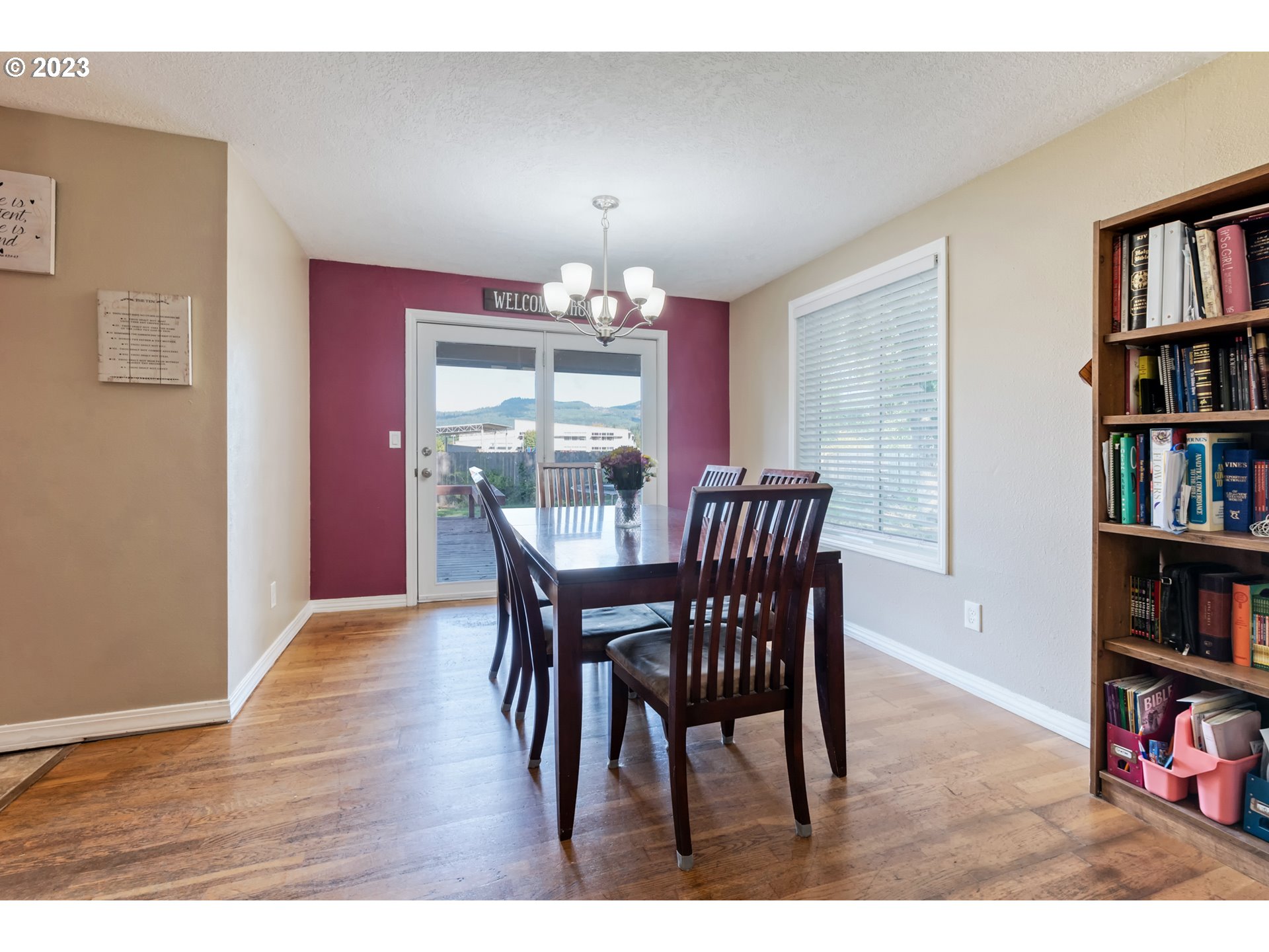 7370 B Street Springfield, OR 97478 - Photo 8 of 41 a view of a dining room with furniture and a book shelf