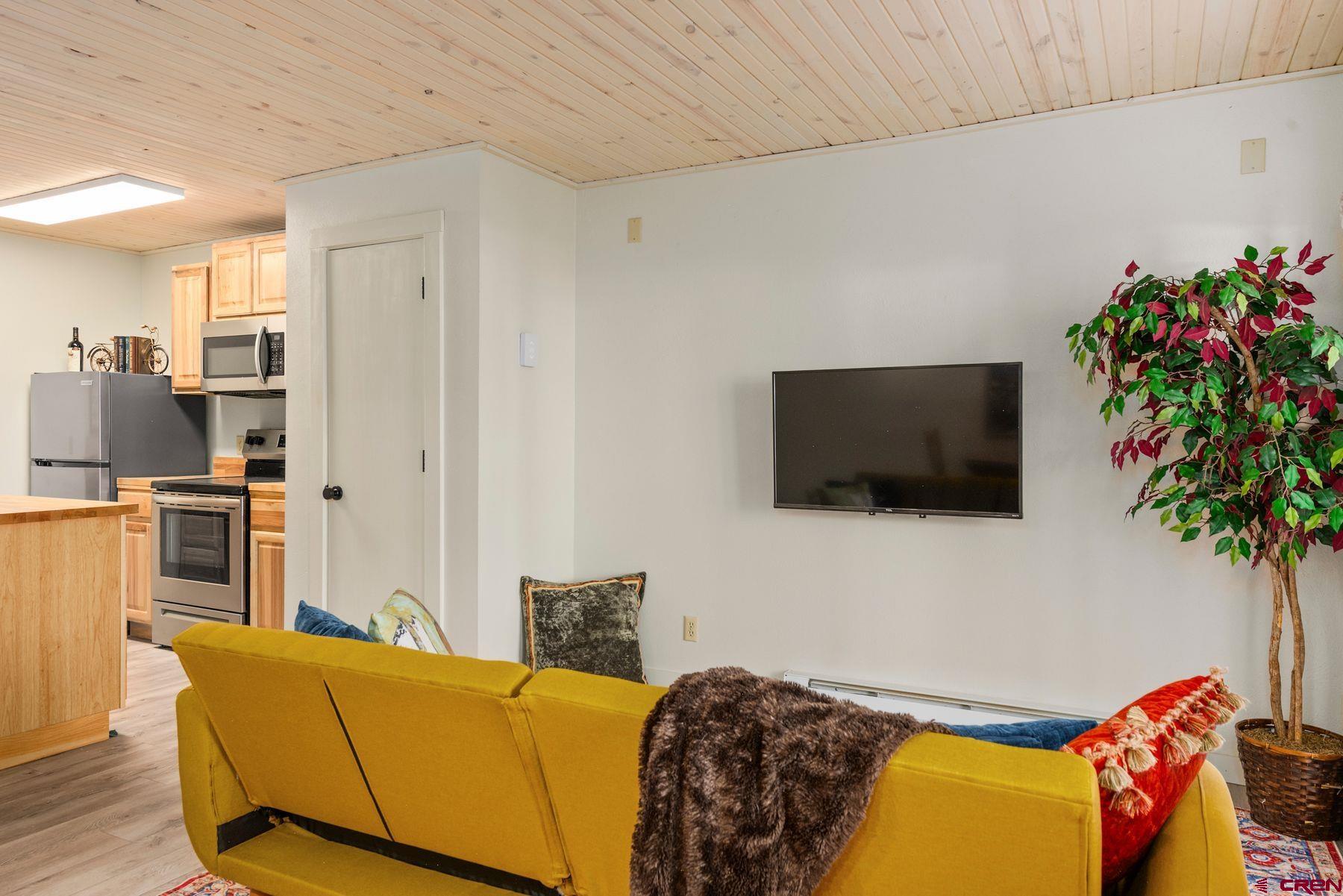 35 Emmons Road, Unit A Crested Butte, CO 81225 - Photo 9 of 28 a living room with furniture and a flat screen tv