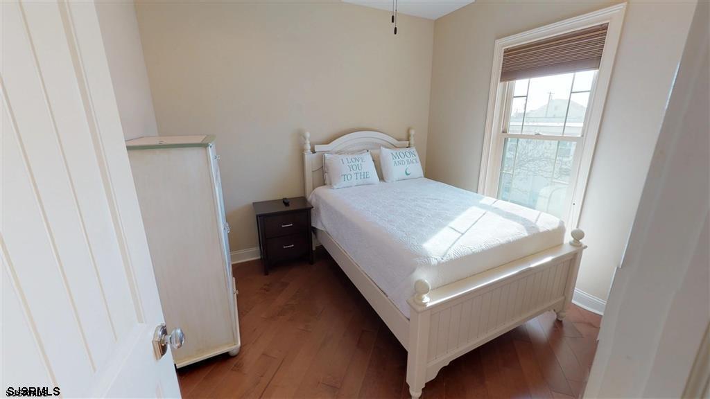 20 South Madison Avenue, Unit B Margate City, NJ 08402 - Photo 12 of 18 a bedroom with a bed and window