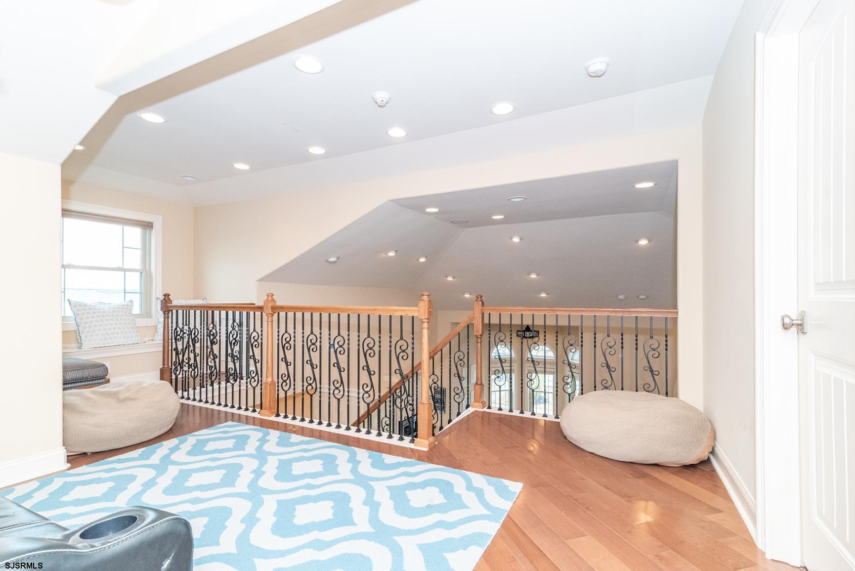 20 South Madison Avenue, Unit B Margate City, NJ 08402 - Photo 14 of 18 a bedroom with a bed and wooden floor