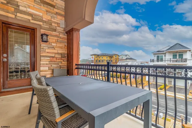 a view of a roof deck with chair and wooden floor