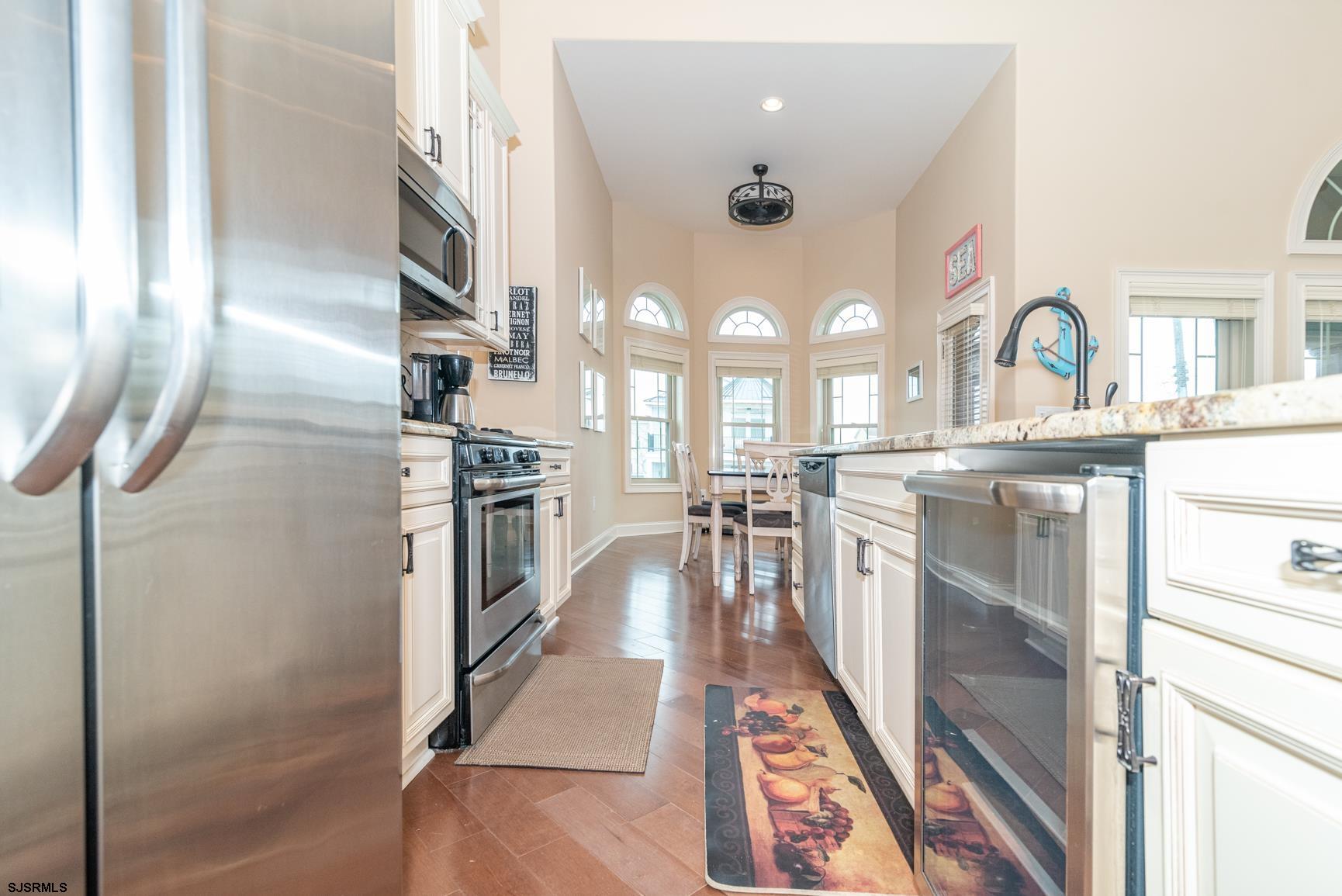 20 South Madison Avenue, Unit B Margate City, NJ 08402 - Photo 5 of 18 a kitchen with stainless steel appliances granite countertop a stove a sink and a refrigerator