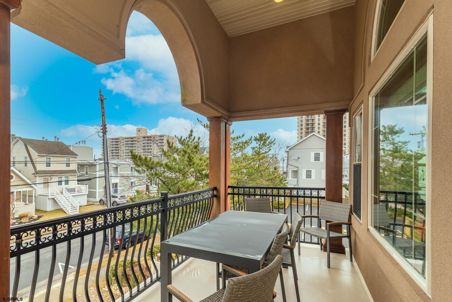 20 South Madison Avenue, Unit B Margate City, NJ 08402 - Photo 7 of 18 a view of a city from a balcony with furniture