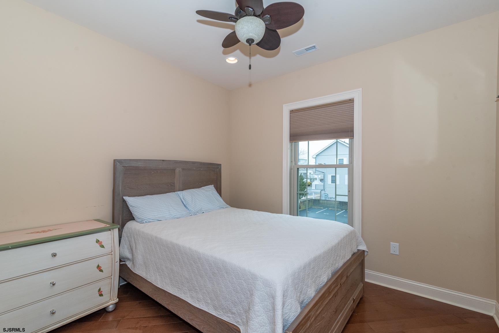 20 South Madison Avenue, Unit B Margate City, NJ 08402 - Photo 10 of 18 a bedroom with a bed and a window