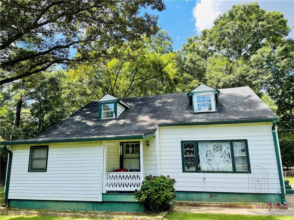 7707 Adamson Road Jonesboro, GA 30236 - Photo 1 of 1 a front view of a house with garden
