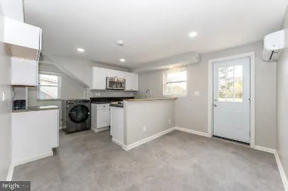 a view of a kitchen with refrigerator and window
