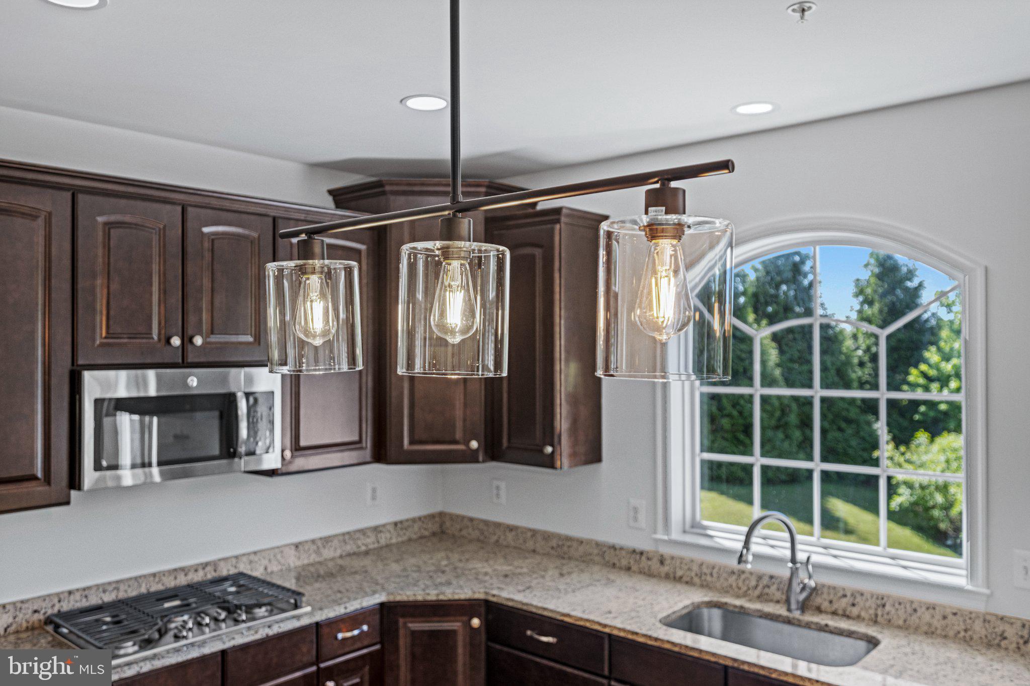 10693 Harding Road Laurel, MD 20723 - Photo 19 of 55 Elegant kitchen with modern lighting.
