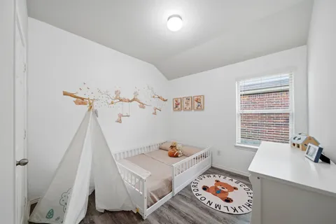 a bedroom with a bed and a potted plant