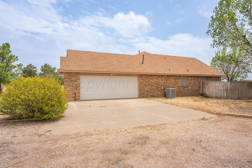 19933 Indian Spring Trail Bushland, TX 79124 - Photo 32 of 32 a front view of a house with a yard and garage