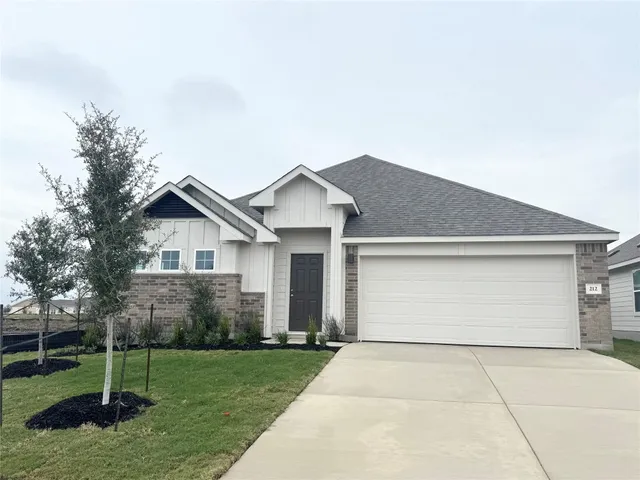 a view of backyard of house with green space
