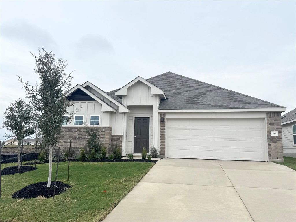 a view of backyard of house with green space