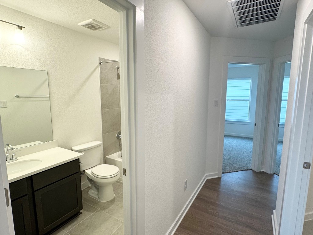 212 Hazy Vw Road San Marcos, TX 78666 - Photo 12 of 20 a bathroom with a sink a toilet a shower and a large mirror
