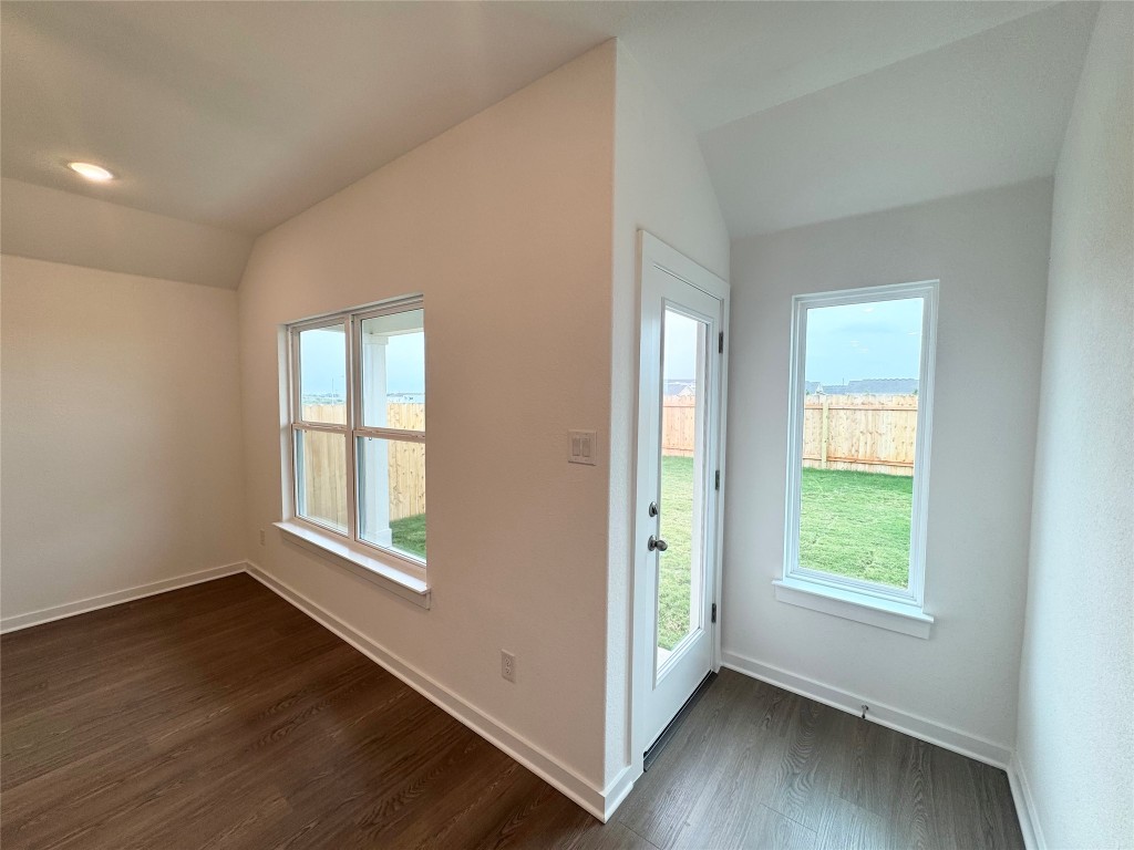 212 Hazy Vw Road San Marcos, TX 78666 - Photo 17 of 20 an empty room with wooden floor and windows