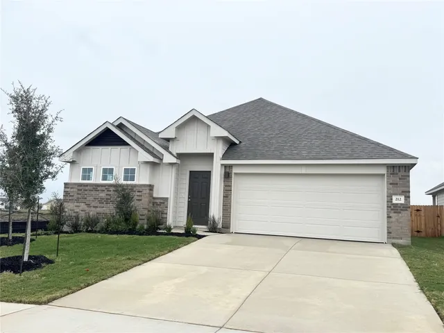 a front view of house with garage and yard