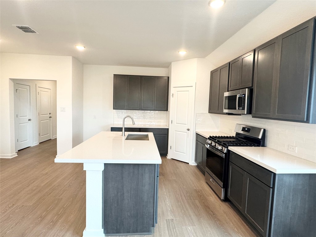 212 Hazy Vw Road San Marcos, TX 78666 - Photo 3 of 20 a kitchen with a stove a sink and a refrigerator