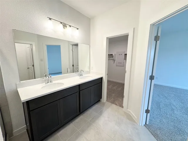a bathroom with a double vanity sink mirror and double