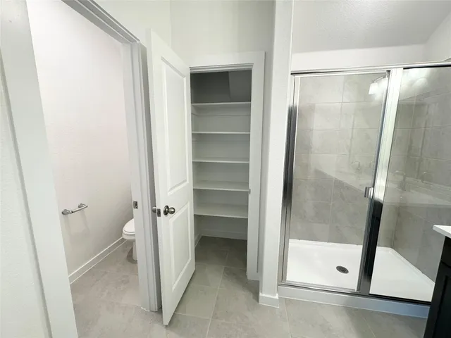 a bathroom with a glass door shower and a sink