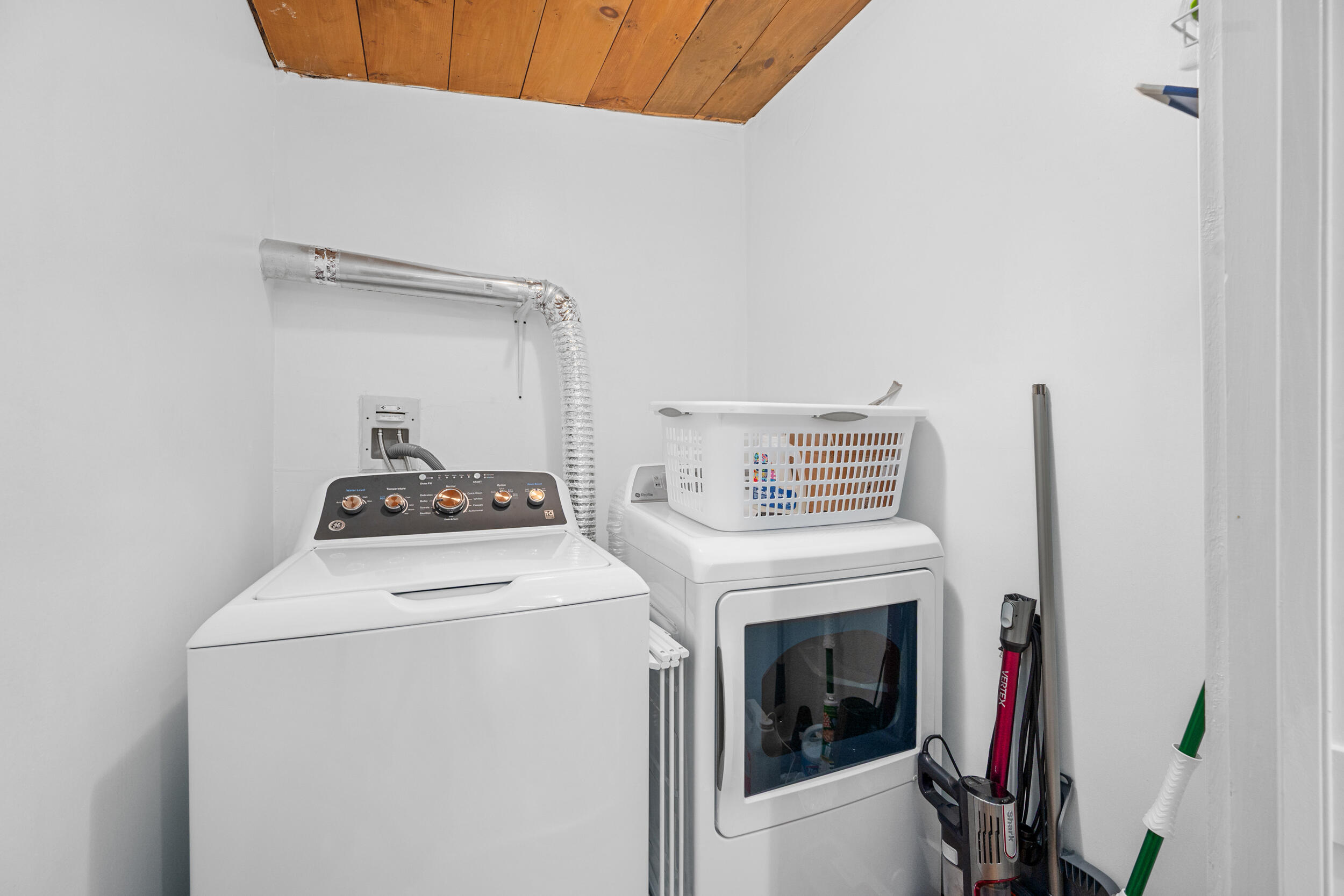 40 Red Lily Pond Road Centerville, MA 02632 - Photo 16 of 25 a view of washer and dryer with kitchen in the background