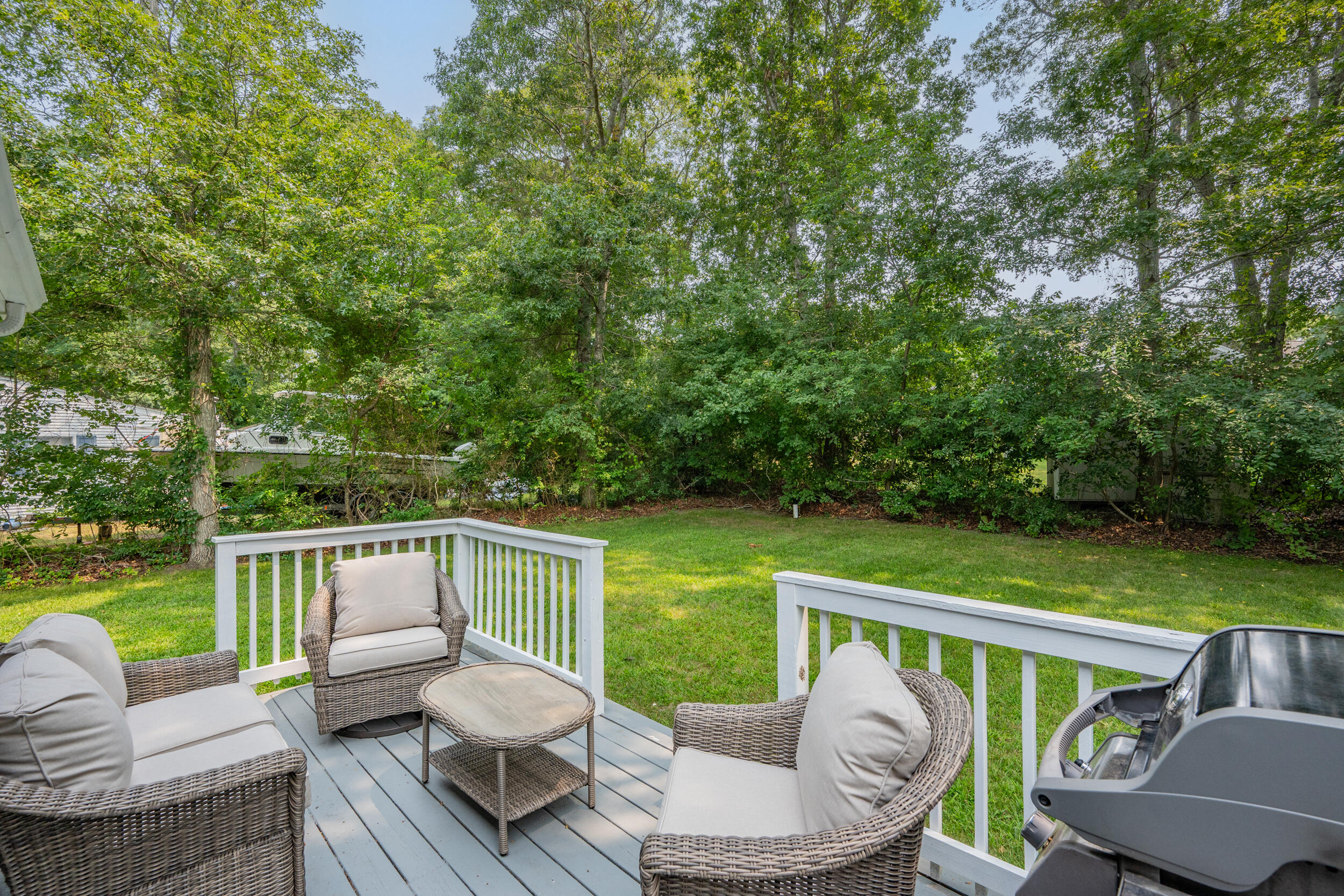 40 Red Lily Pond Road Centerville, MA 02632 - Photo 18 of 25 a view of a chair and tables in the deck