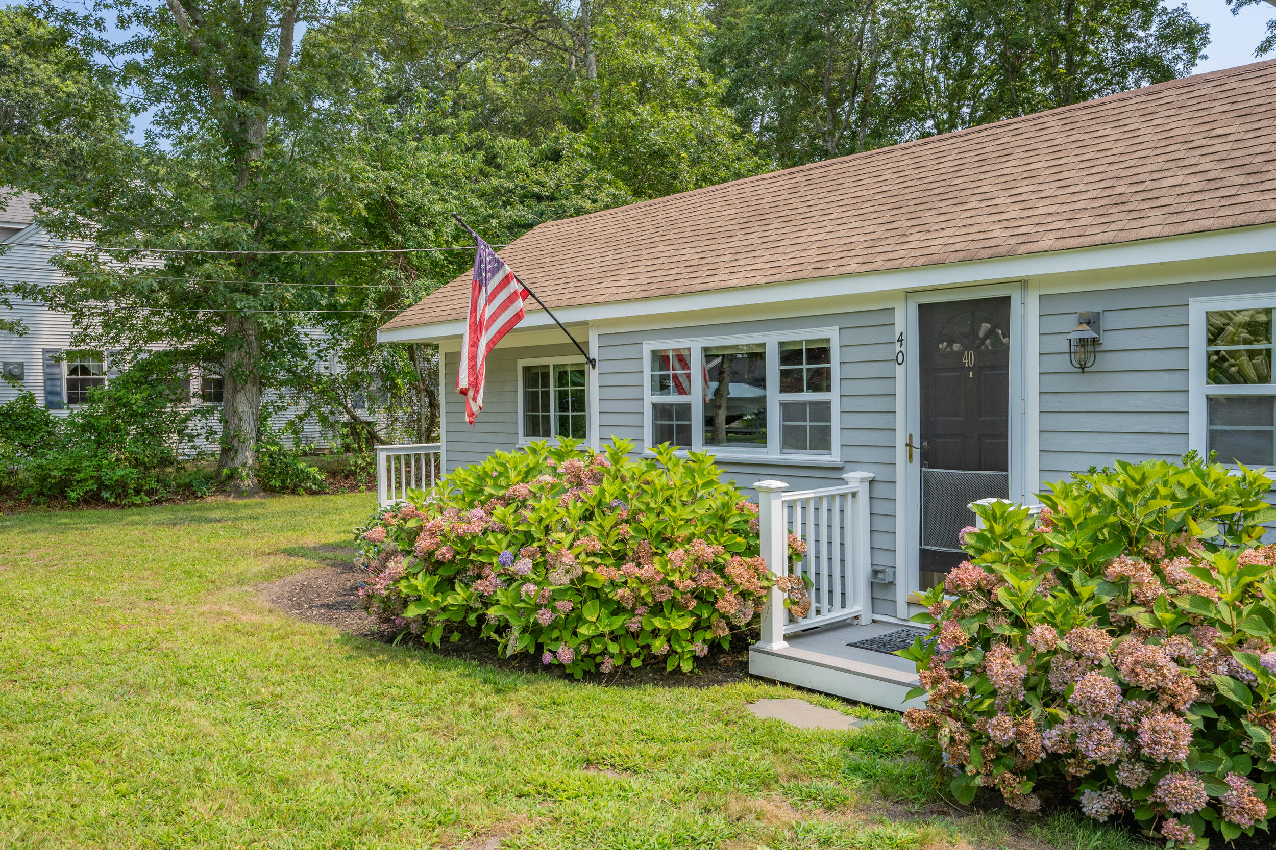 40 Red Lily Pond Road Centerville, MA 02632 - Photo 2 of 25 a front view of a house with garden