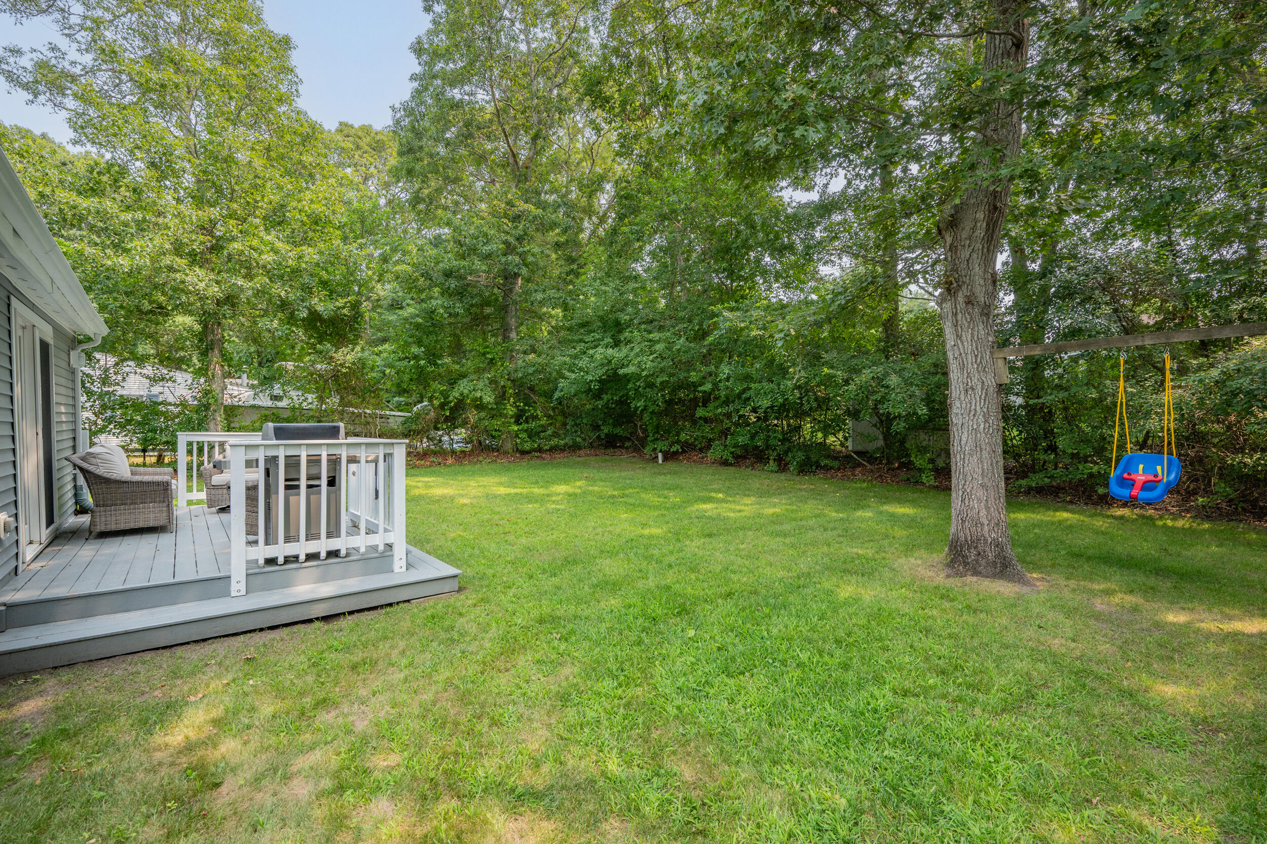 40 Red Lily Pond Road Centerville, MA 02632 - Photo 21 of 25 a view of a chair and table on the green field