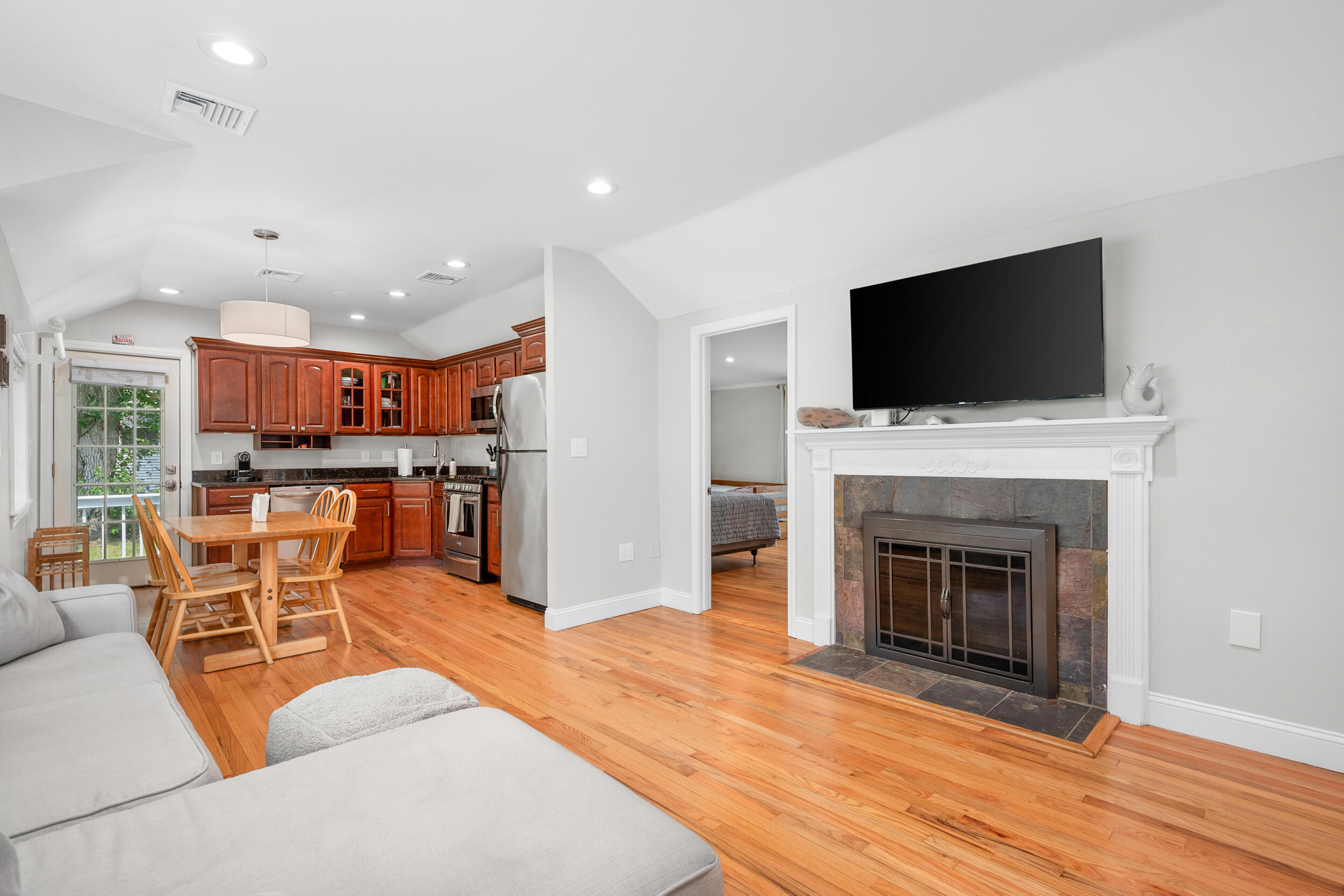 40 Red Lily Pond Road Centerville, MA 02632 - Photo 7 of 25 a living room with furniture a fireplace and a flat screen tv