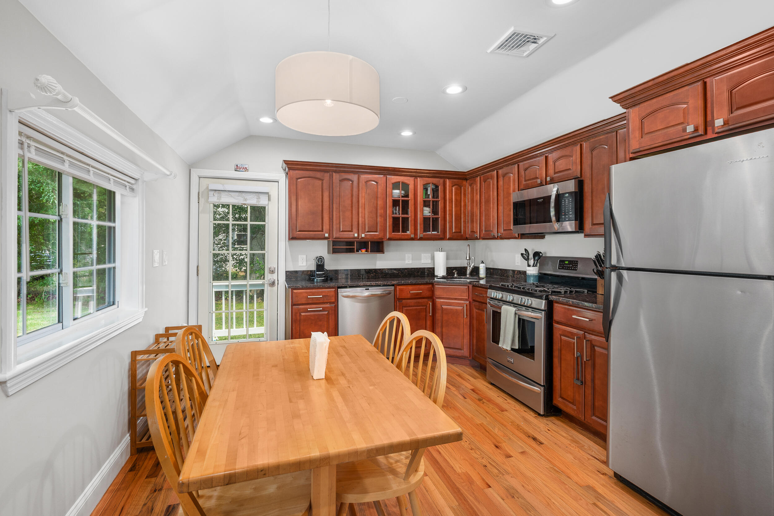 40 Red Lily Pond Road Centerville, MA 02632 - Photo 9 of 25 a kitchen with stainless steel appliances granite countertop a refrigerator a stove top oven a sink dishwasher and wooden cabinets with wooden floor