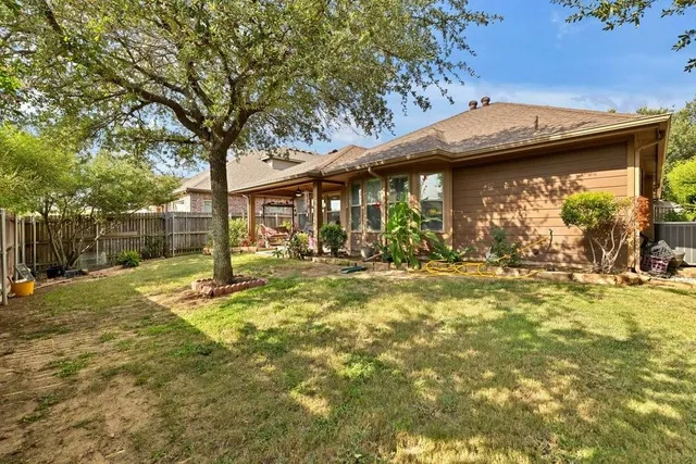 a backyard of a house with table and chairs