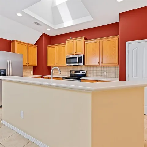a kitchen with stainless steel appliances a sink and a microwave