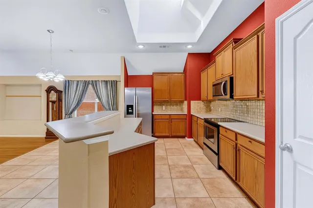 a kitchen with stainless steel appliances kitchen island granite countertop a sink and cabinets