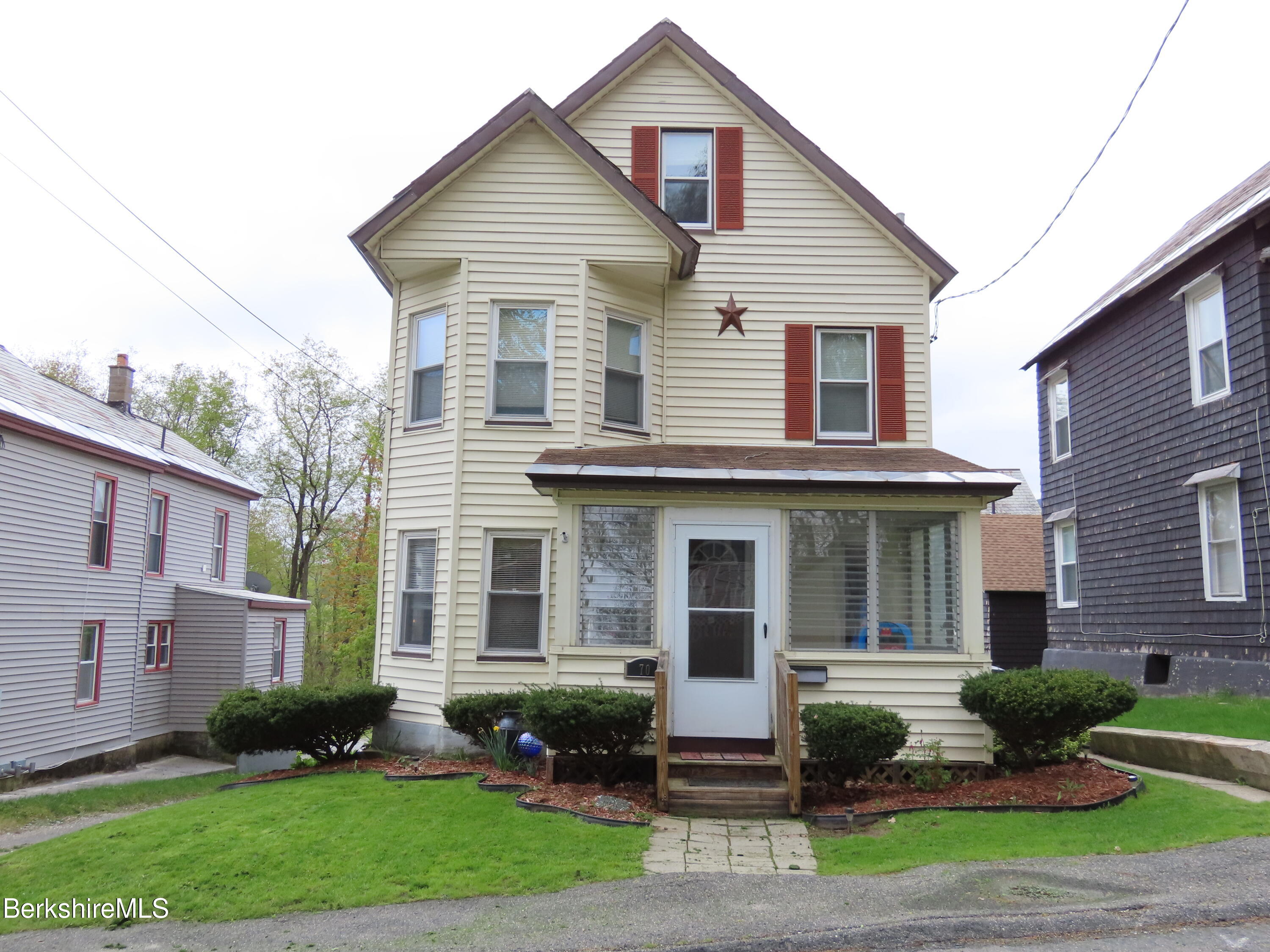 a front view of a house with garden and porch