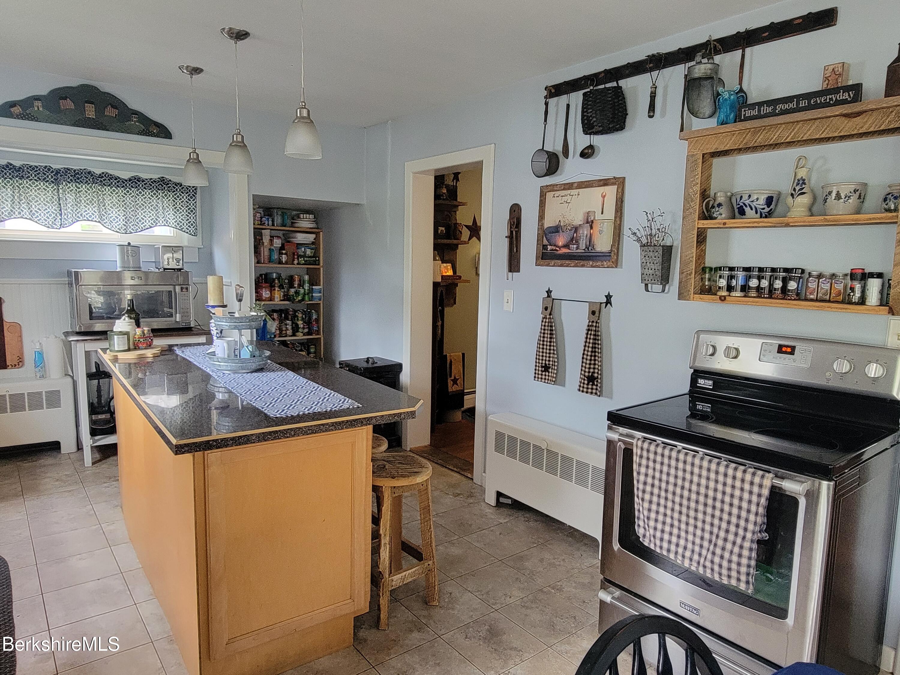 70 Frederick Street North Adams, MA 01247 - Photo 11 of 37 a kitchen that has a stove and a table
