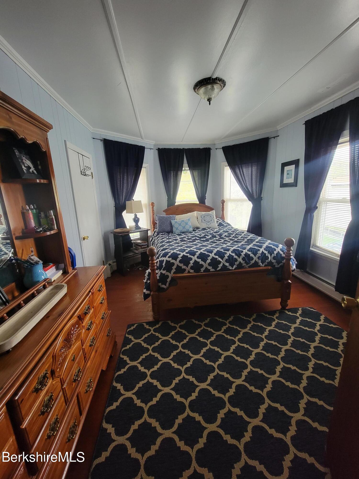 70 Frederick Street North Adams, MA 01247 - Photo 19 of 37 a living room with a large bed and a dresser next to a window