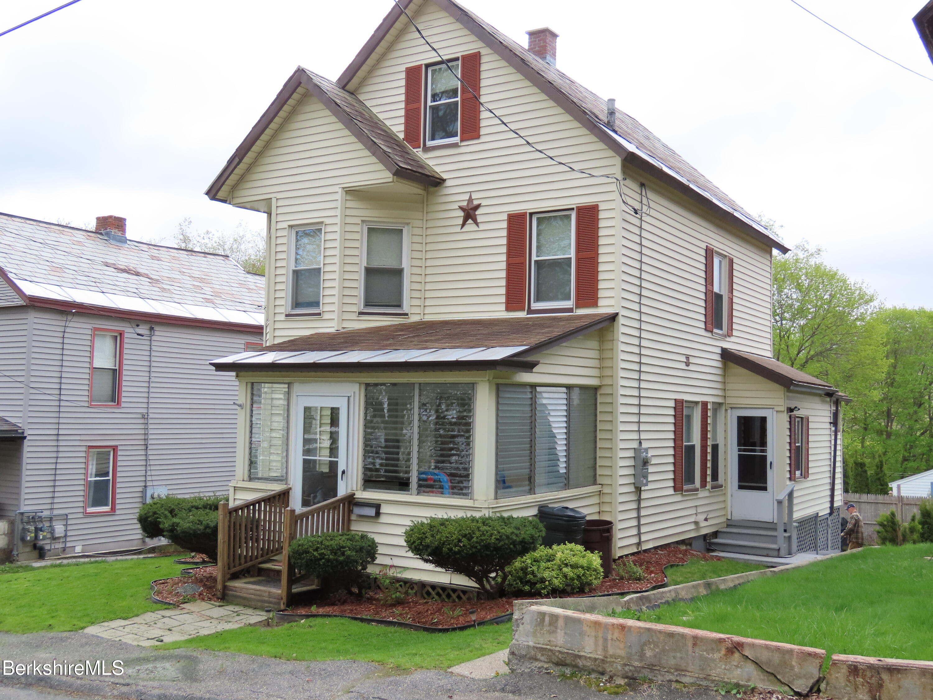 70 Frederick Street North Adams, MA 01247 - Photo 2 of 37 a front view of a house with a yard and plants