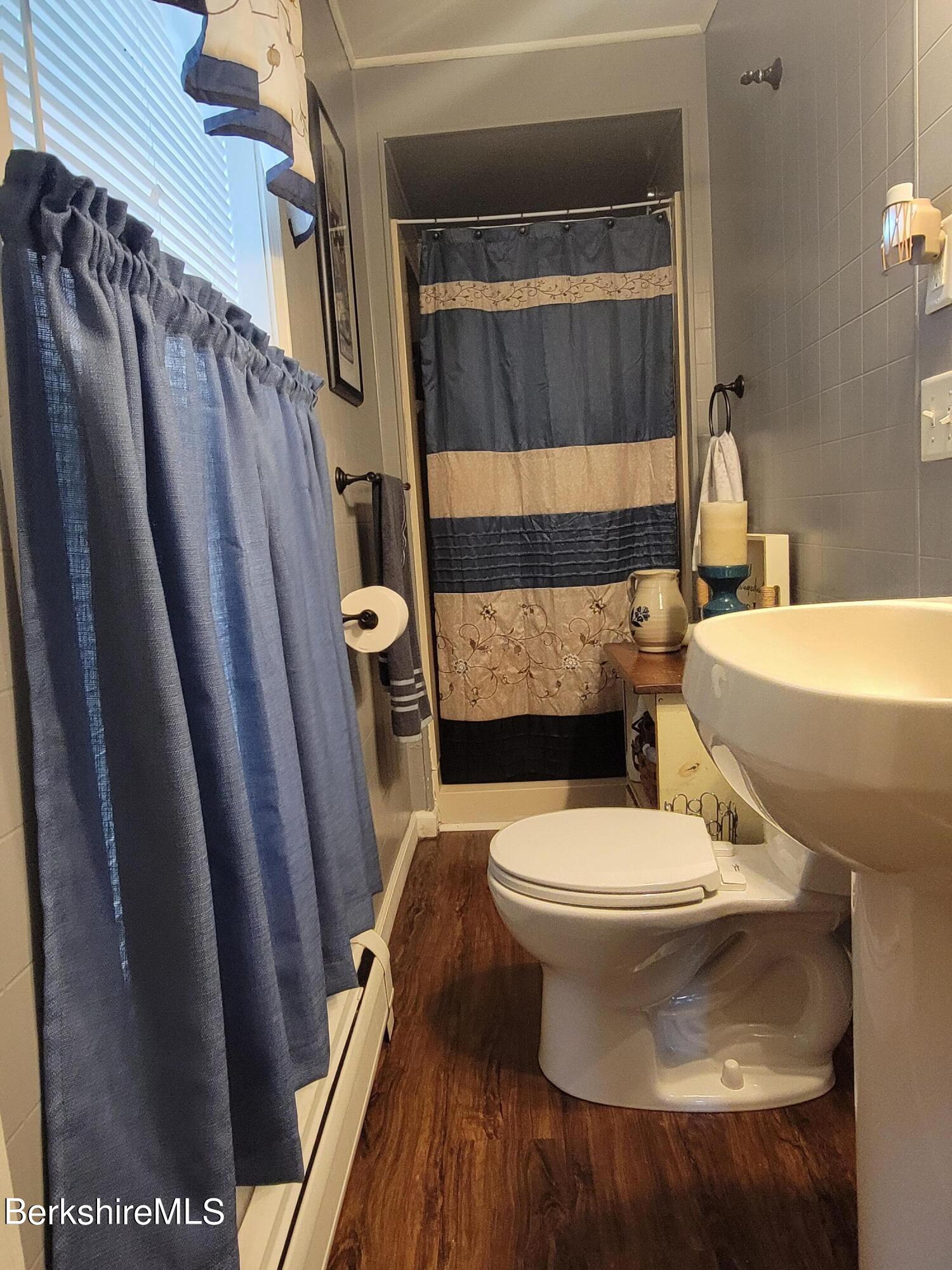 70 Frederick Street North Adams, MA 01247 - Photo 21 of 37 a white toilet sitting next to a sink and vanity