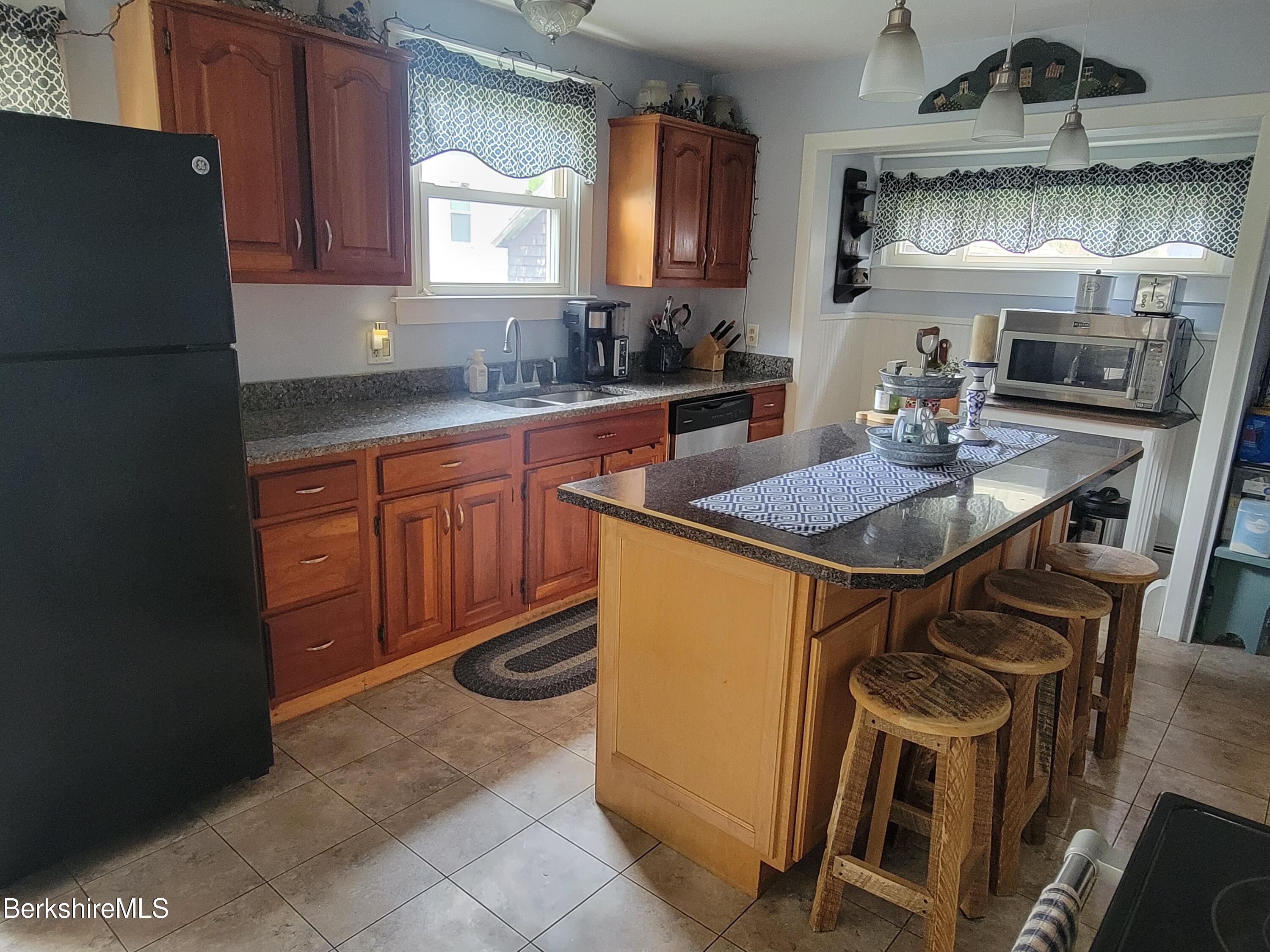 70 Frederick Street North Adams, MA 01247 - Photo 5 of 37 a kitchen with stainless steel appliances granite countertop a sink refrigerator and microwave