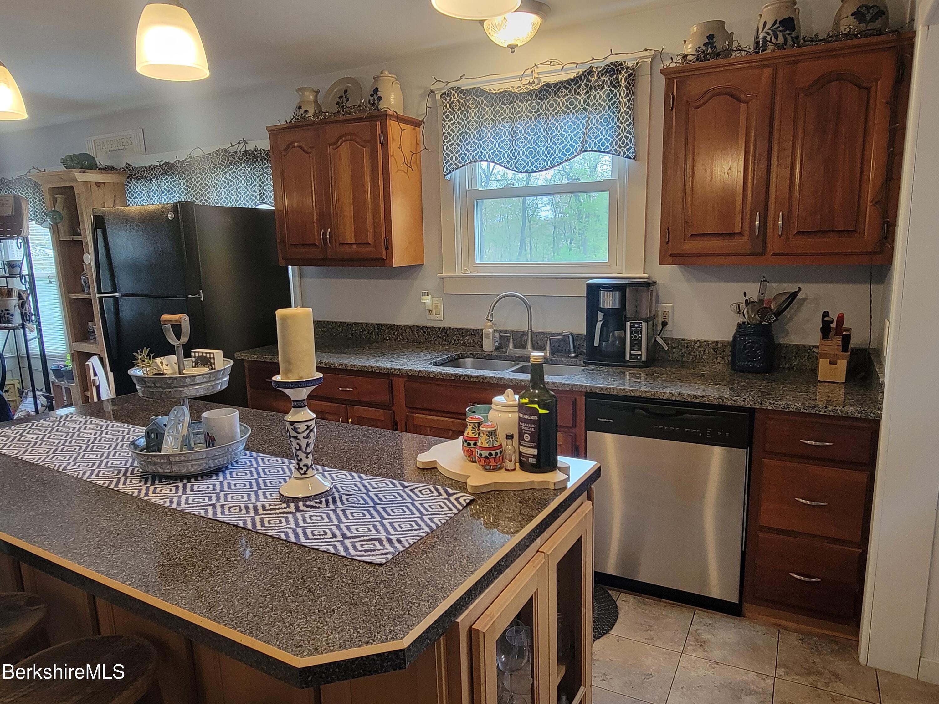 70 Frederick Street North Adams, MA 01247 - Photo 6 of 37 a kitchen with granite countertop a sink stove and cabinets