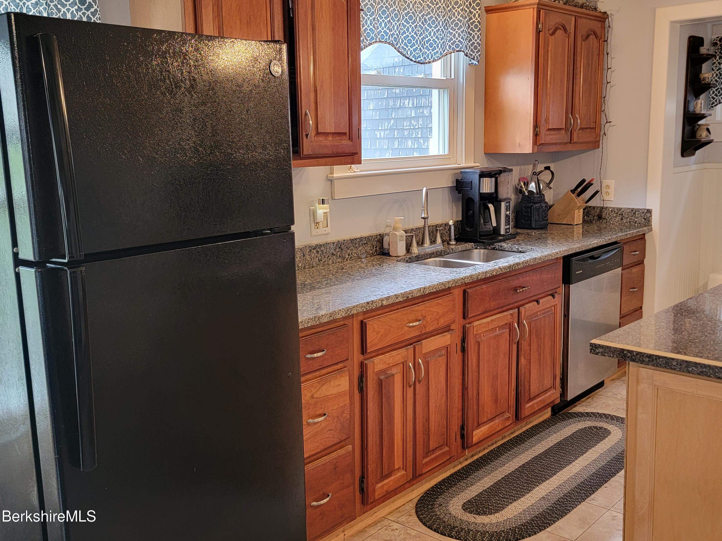 70 Frederick Street North Adams, MA 01247 - Photo 7 of 37 a kitchen with stainless steel appliances granite countertop a refrigerator a sink and a stove