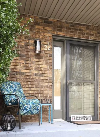 a brick building with a bench in front of it