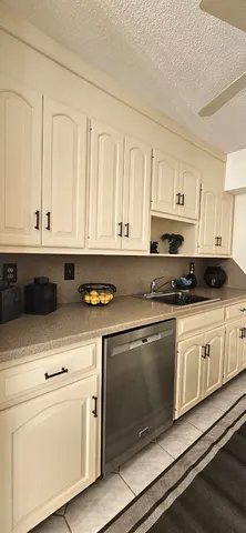 a kitchen with stainless steel appliances granite countertop white cabinets sink and granite counter tops