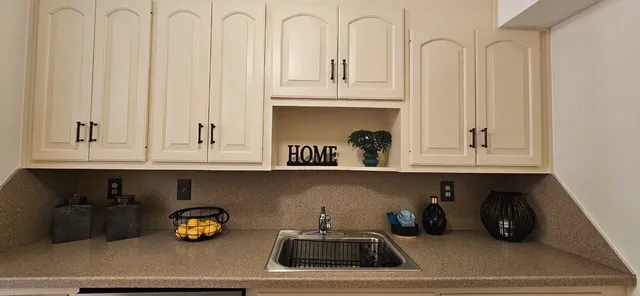 a kitchen with a sink a stove and cabinets
