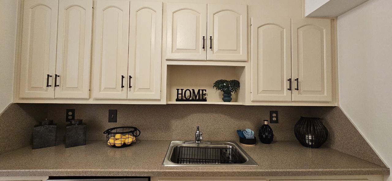 25 Washington Street, Unit 22 Bristol, CT 06010 - Photo 12 of 40 a kitchen with a sink a stove and cabinets