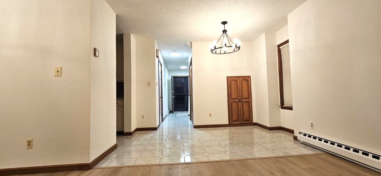 25 Washington Street, Unit 22 Bristol, CT 06010 - Photo 15 of 40 an empty room with wooden floor and mirror