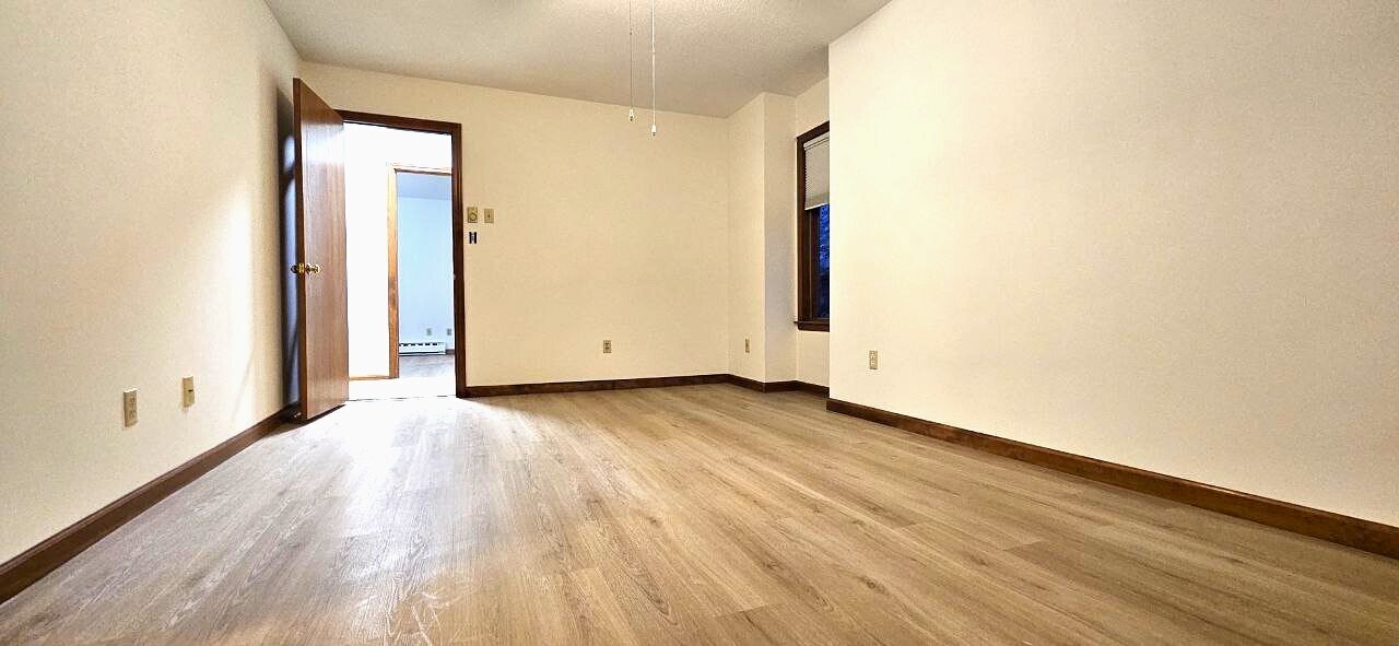 25 Washington Street, Unit 22 Bristol, CT 06010 - Photo 22 of 40 an empty room with wooden floor and windows