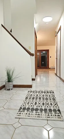 a view of a hallway with wooden floor and a fireplace