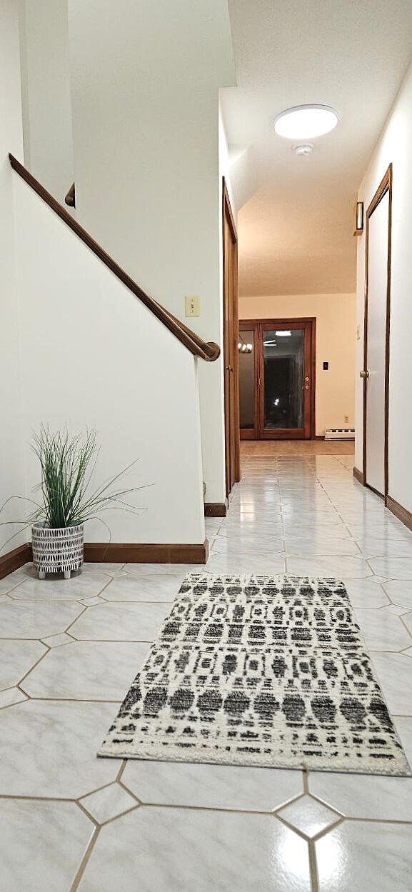 25 Washington Street, Unit 22 Bristol, CT 06010 - Photo 6 of 40 a view of a hallway with wooden floor and a fireplace