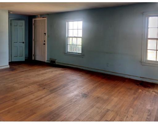 959 Bradley Road Springfield, MA 01109 - Photo 8 of 15 an empty room with wooden floor and windows