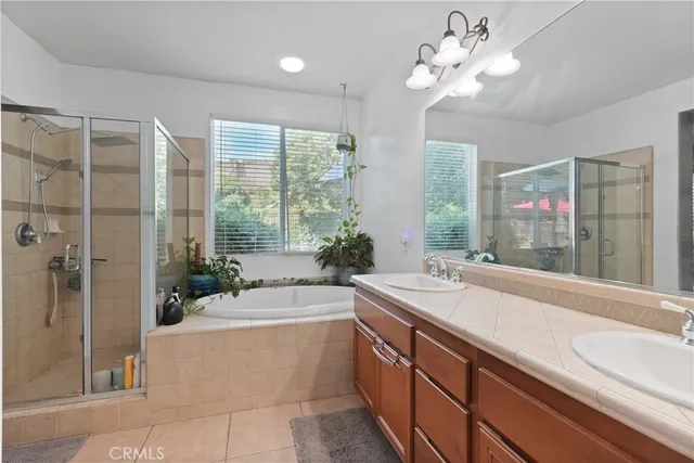 a spacious bathroom with a granite countertop sink a large mirror and a bathtub